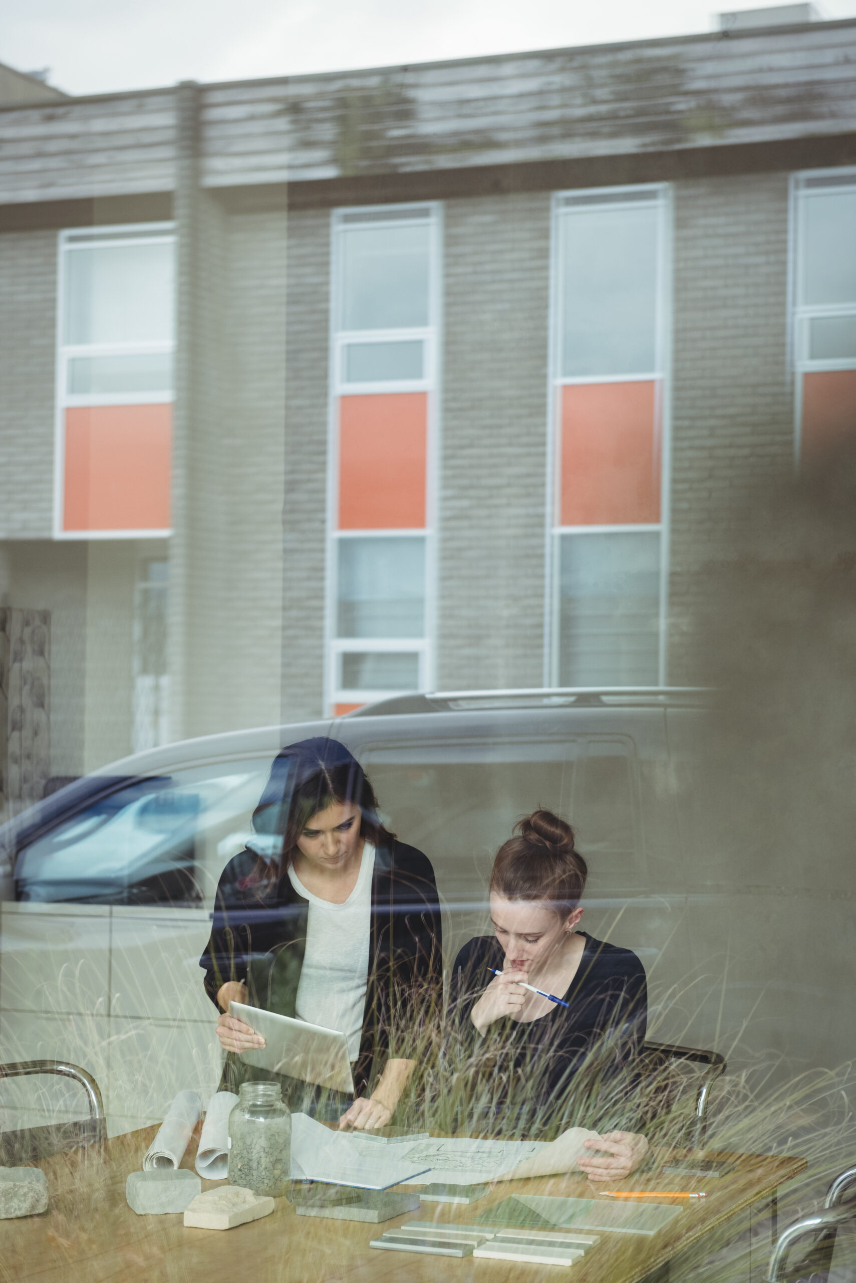 Business executives discussing over blueprint in office