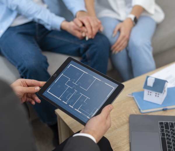 male-real-estate-agent-doing-business-showing-house-potential-buying-couple
