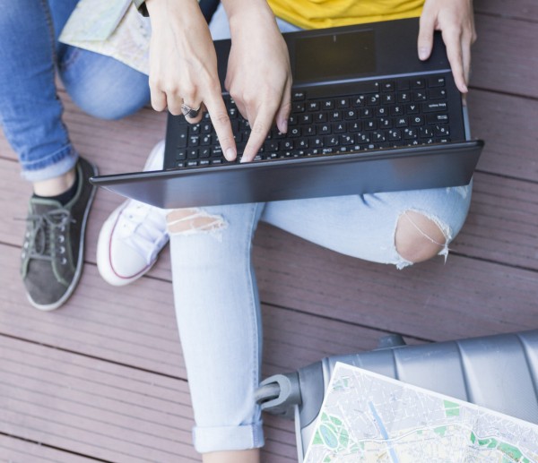 two beautiful women looking a map. green background. They are la